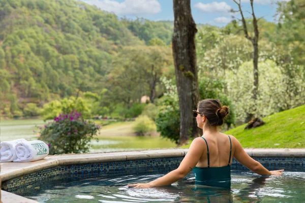 Sierra Lago Resort & Spa - Woman entering an outdoor jacuzzi with towels and lake views