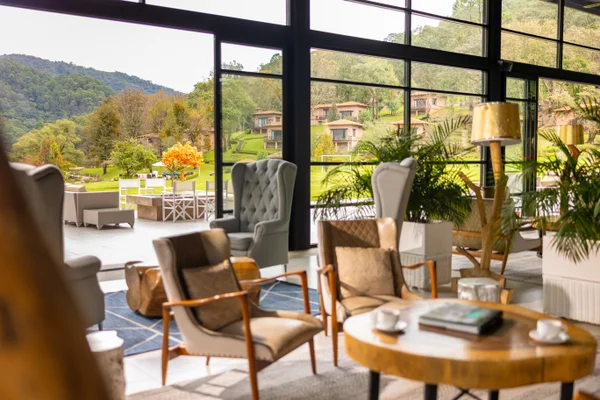 Sierra Lago Resort & Spa - Armchairs, coffee cups and books on a wooden table in the lounge with mountain views