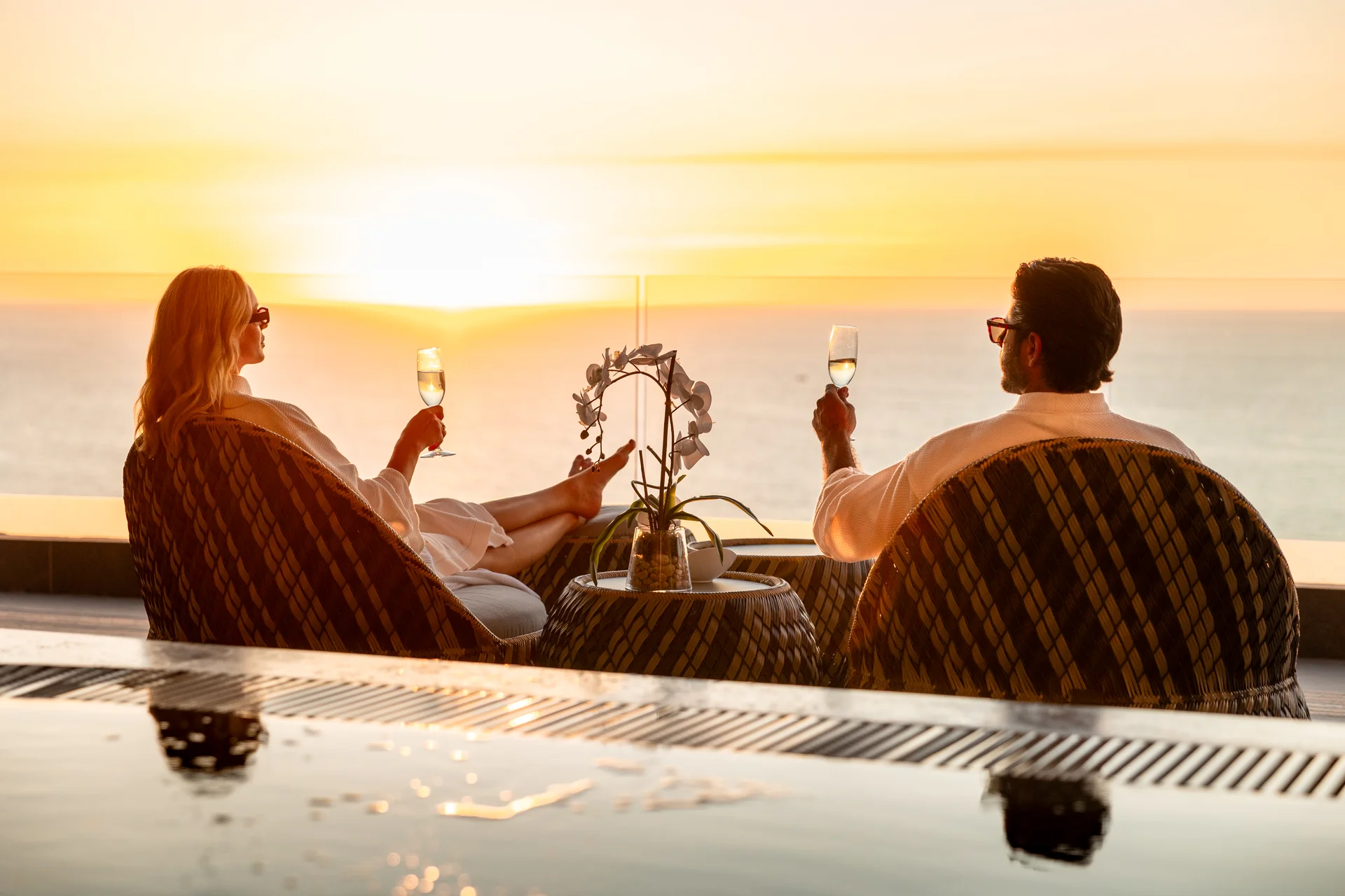 Couple toasting with champagne at sunset over the Pacific at Garza Blanca Puerto Vallarta