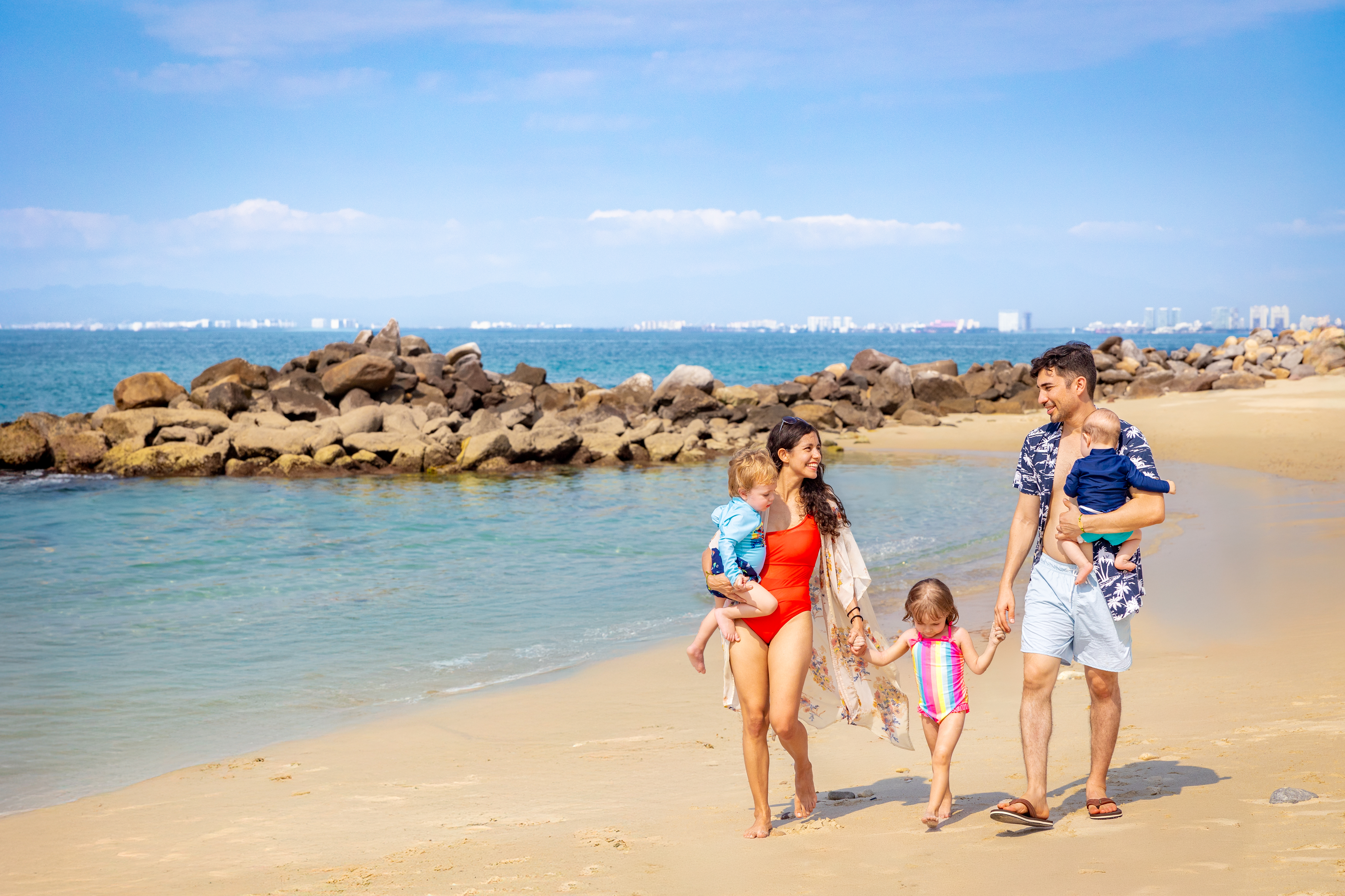 family of 5 walking on the beach