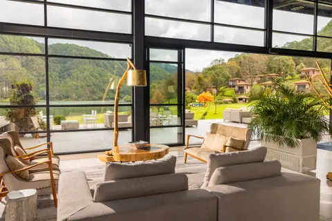 Sierra Lago Resort & Spa - Sofas and armchairs in the lounge facing the lake and forested hills
