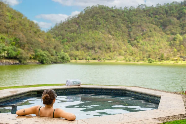 Sierra Lago Resort & Spa - Woman in an outdoor jacuzzi facing the lake and green mountains