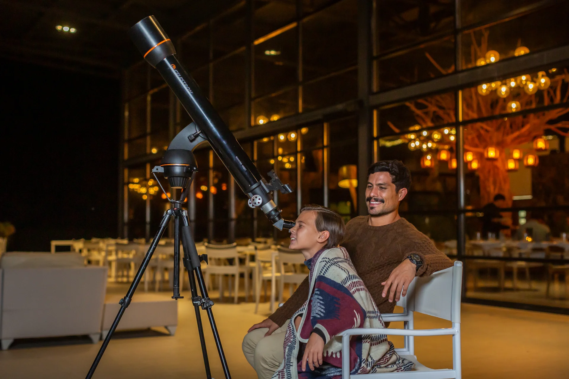 Sierra Lago Resort & Spa - Father and son stargazing with a telescope on the terrace at night