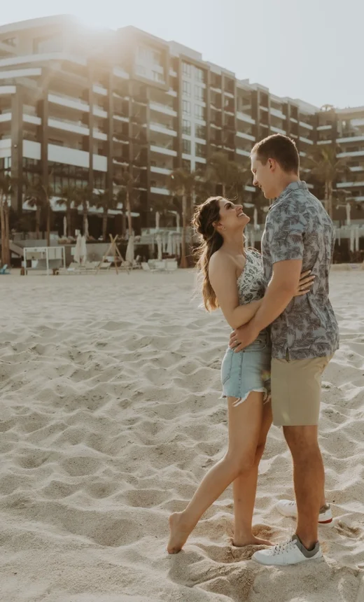 Couple embracing on the beach at Garza Blanca Los Cabos