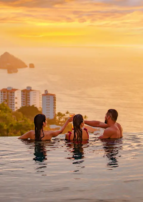 Family enjoying the sunset from the infinity pool at Hotel Mousai Puerto Vallarta