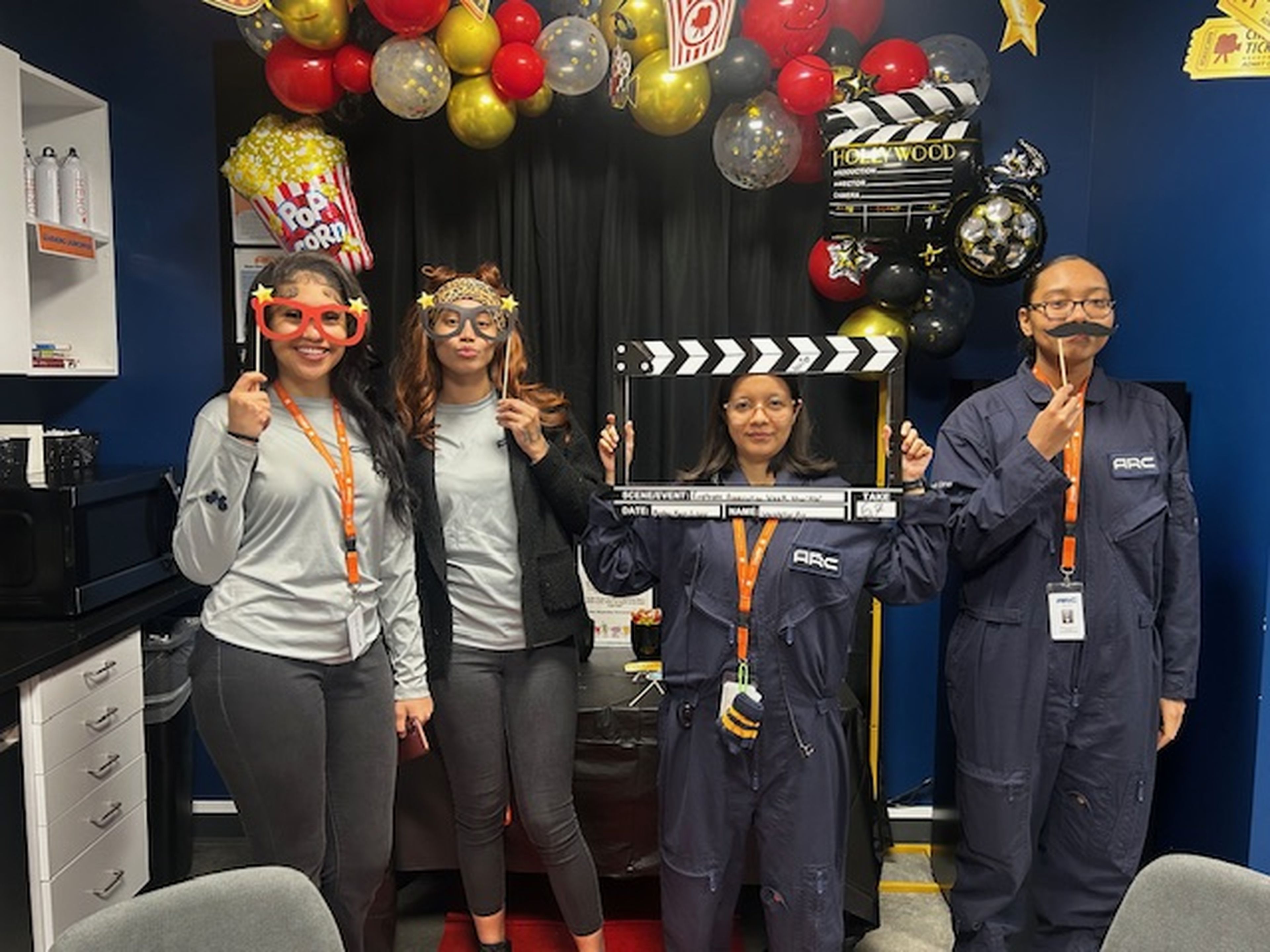 Team celebration with movie-themed photo booth props