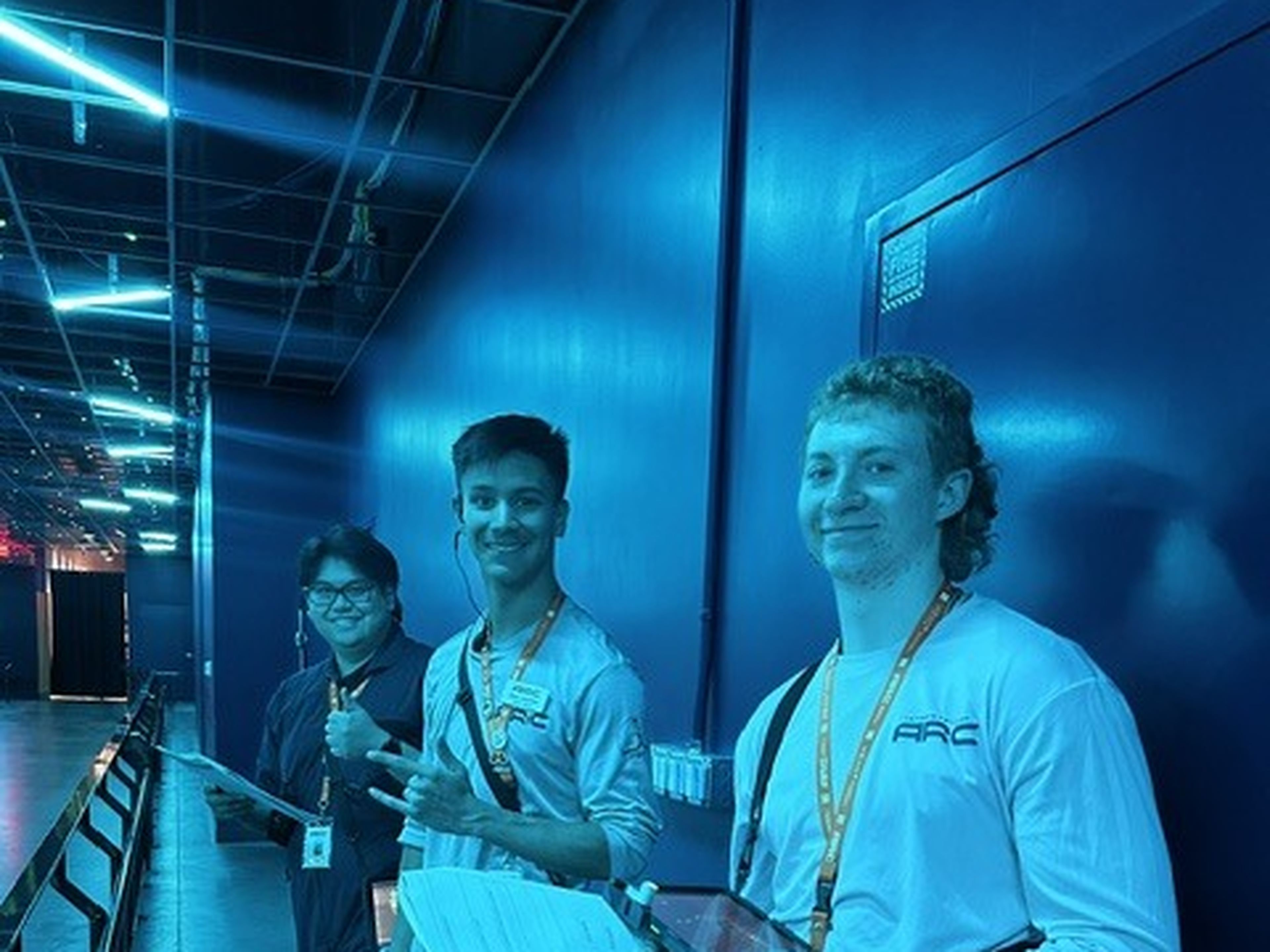 Arc crew members welcoming guests inside the experience