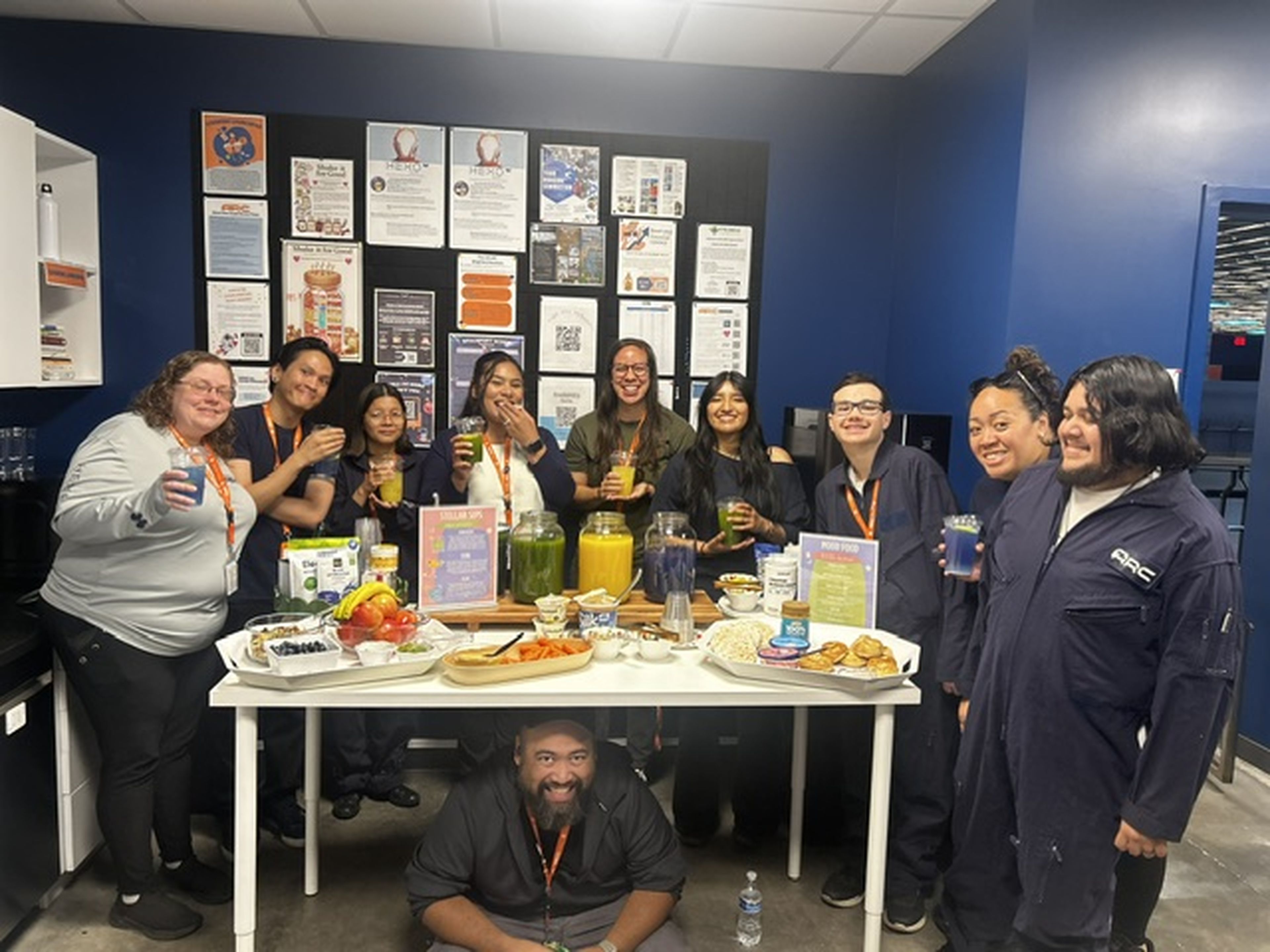 Team wellness gathering with fresh smoothies in the Arc break room