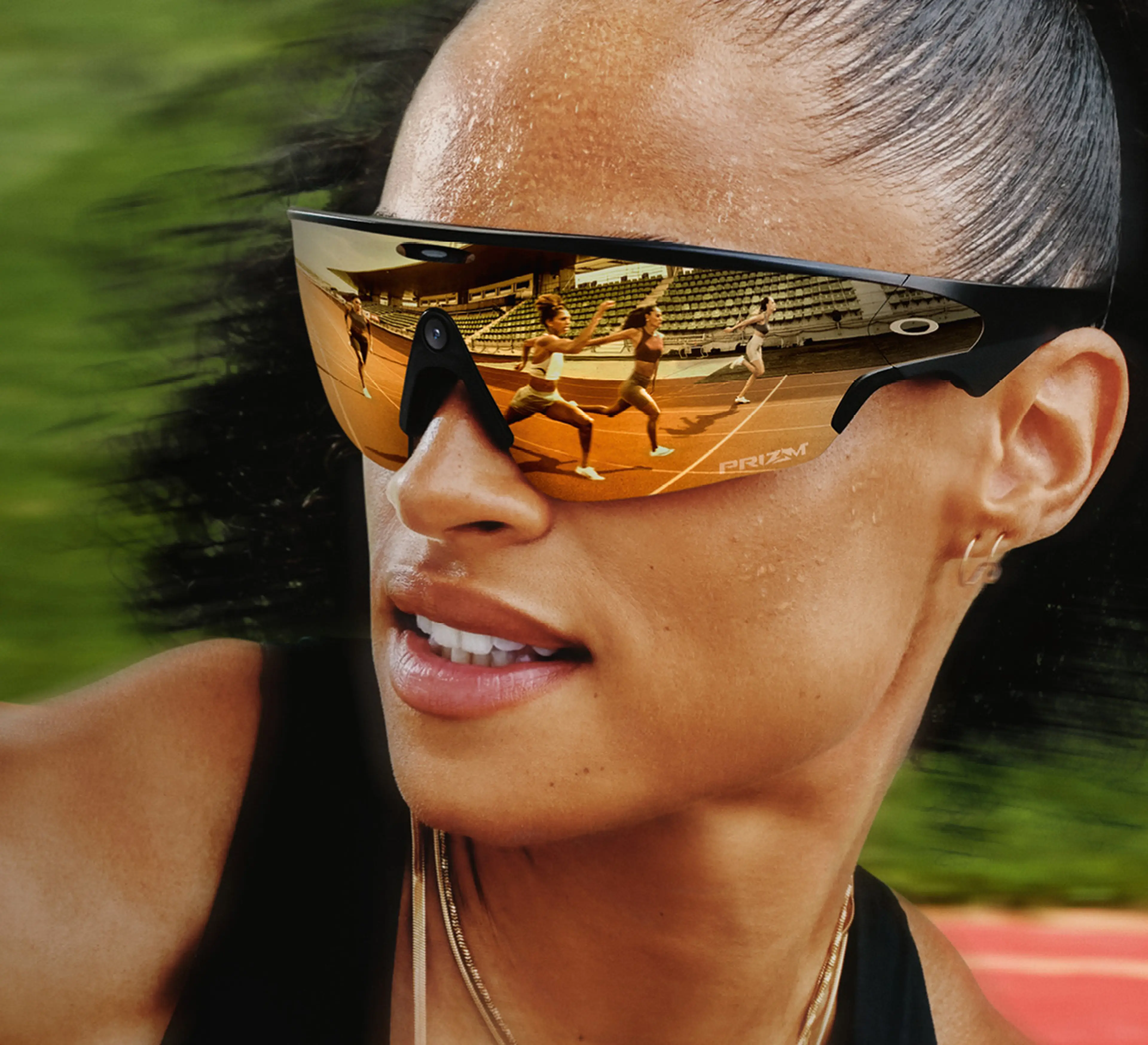 Close-up of a woman wearing Meta AI glasses, showing runners on a track reflected in the lenses.
