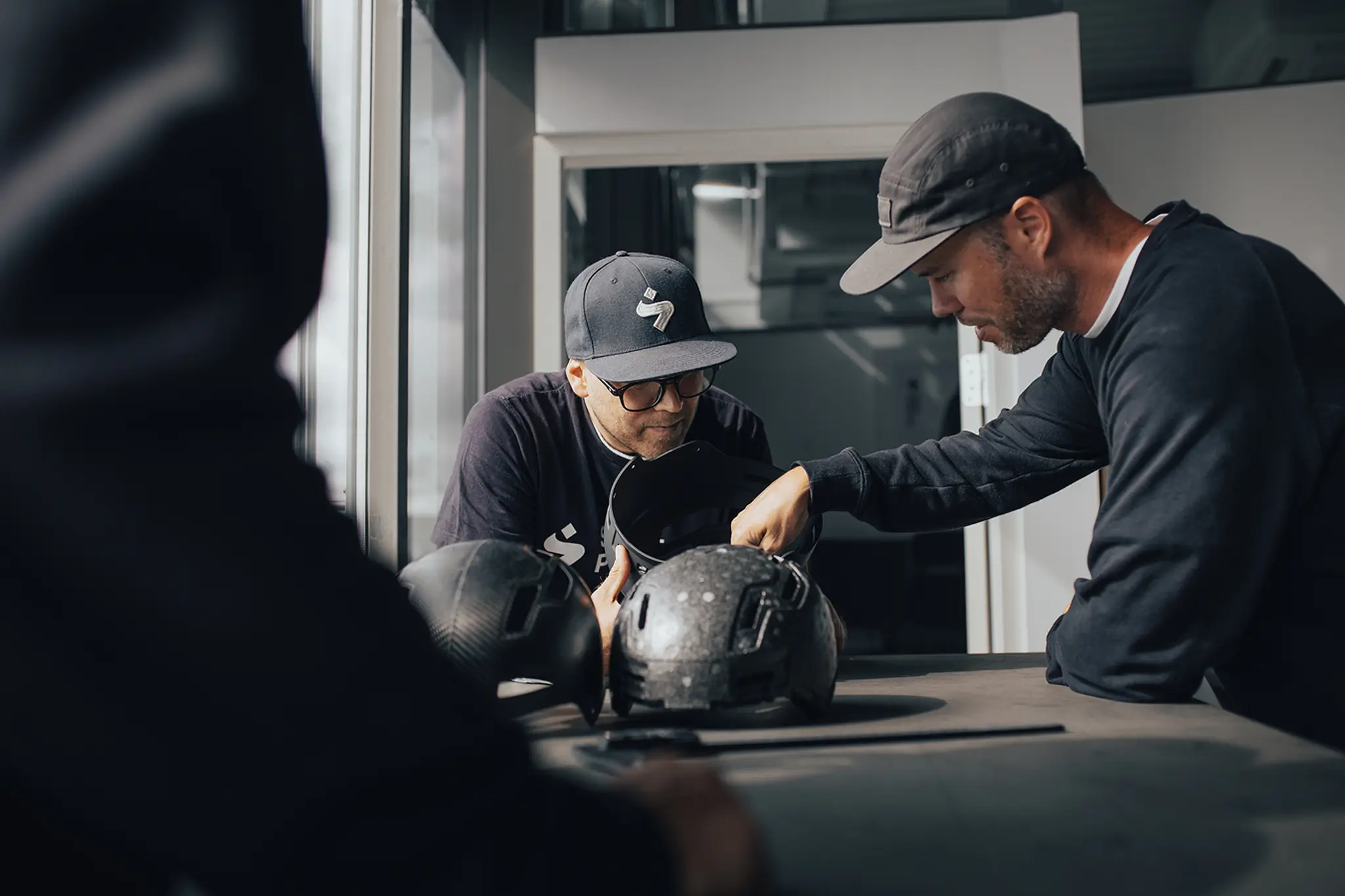 Sweet Protection engineers examining a 2Vi® helmet shell and liner