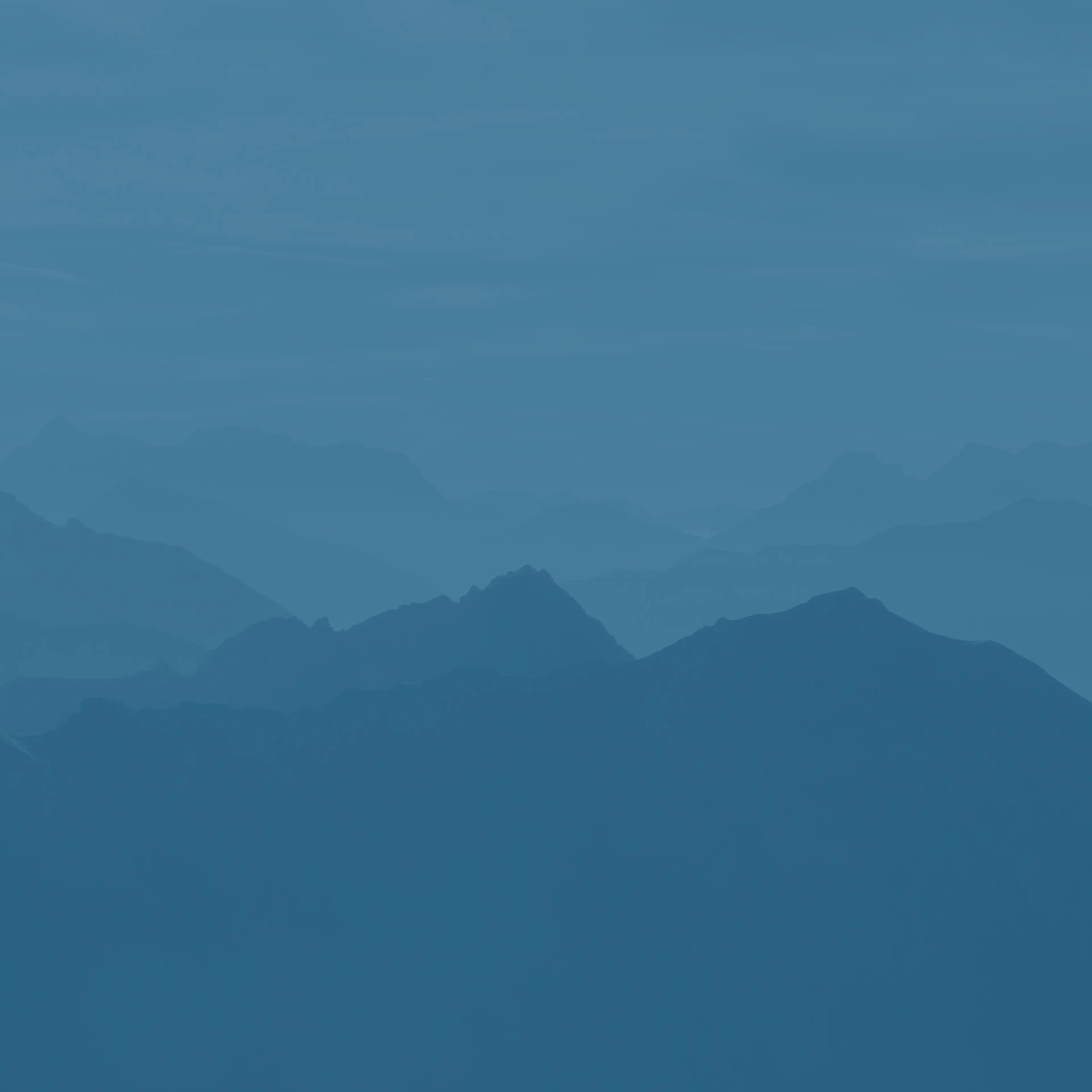 Silhouettes of mountains in various shades of blue