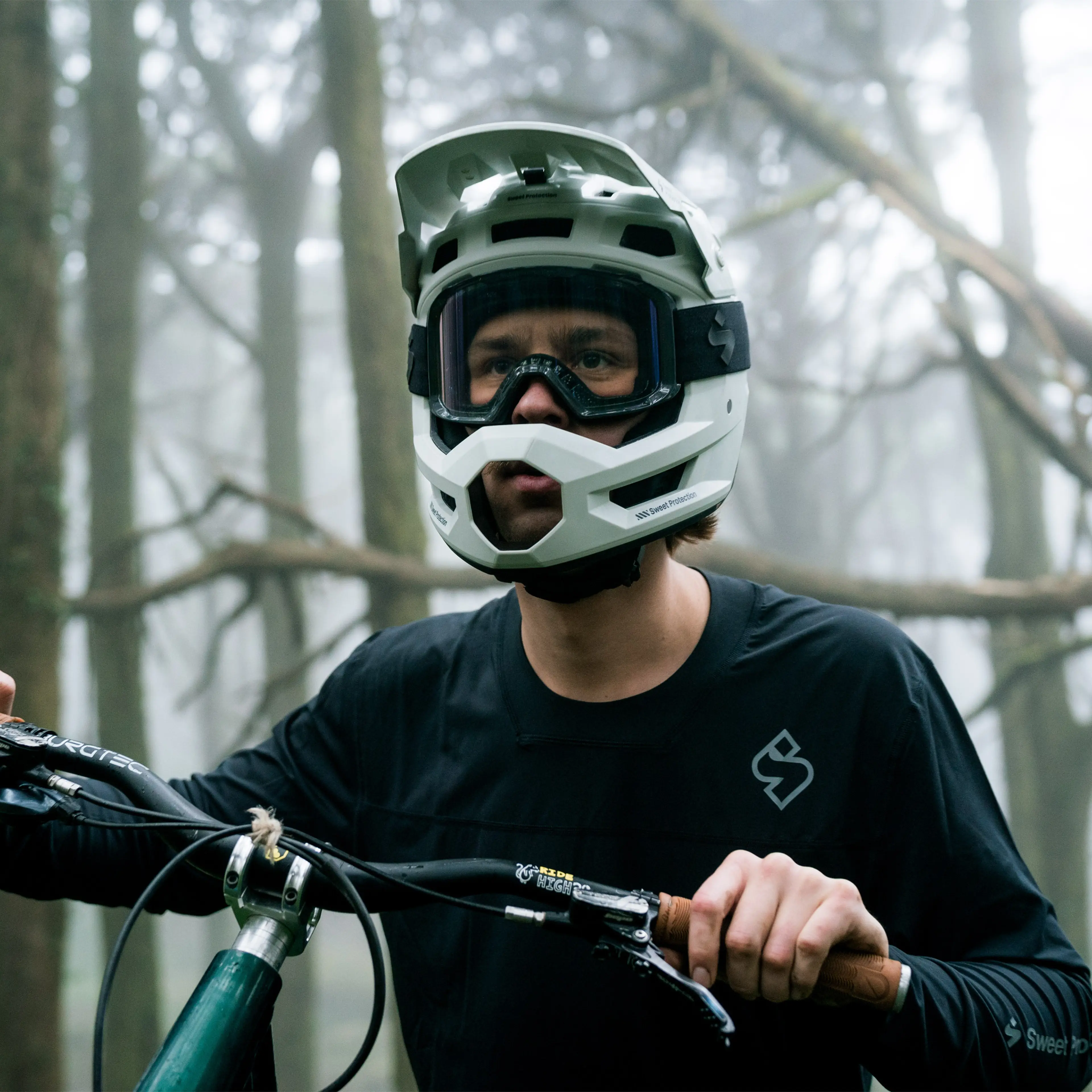 Man in Full Face MTB Helmet from Sweet Protection leading his bike
