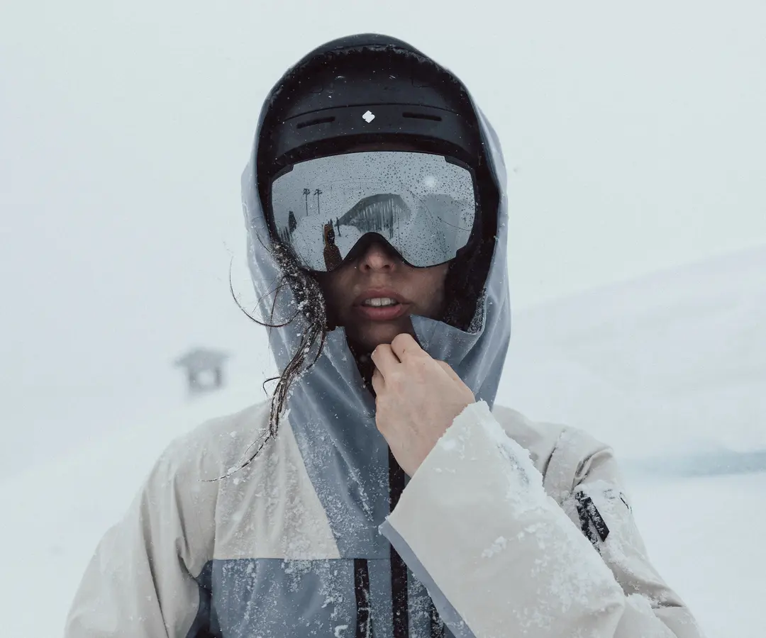 Girl wearing ski goggles on a snowy mountain