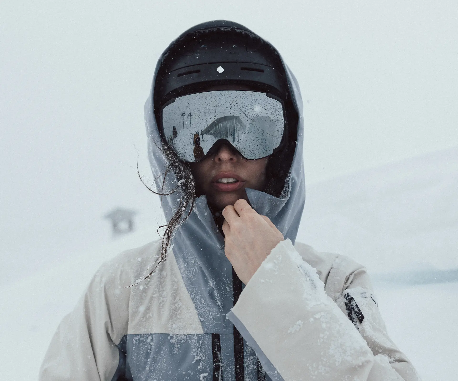 Girl wearing ski goggles on a snowy mountain