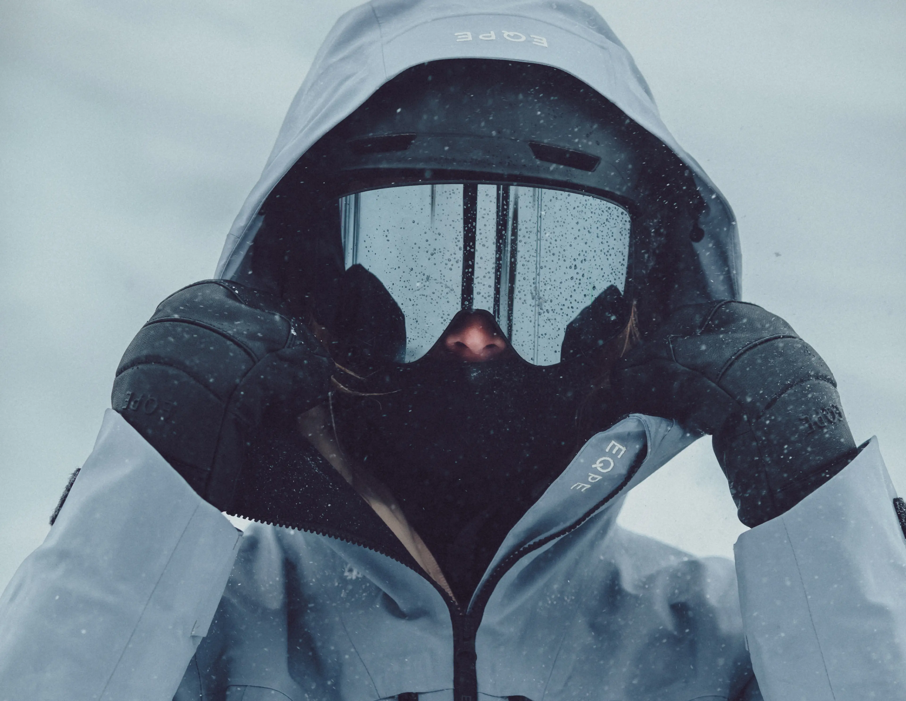 Person in ski gear standing in snowy conditions.