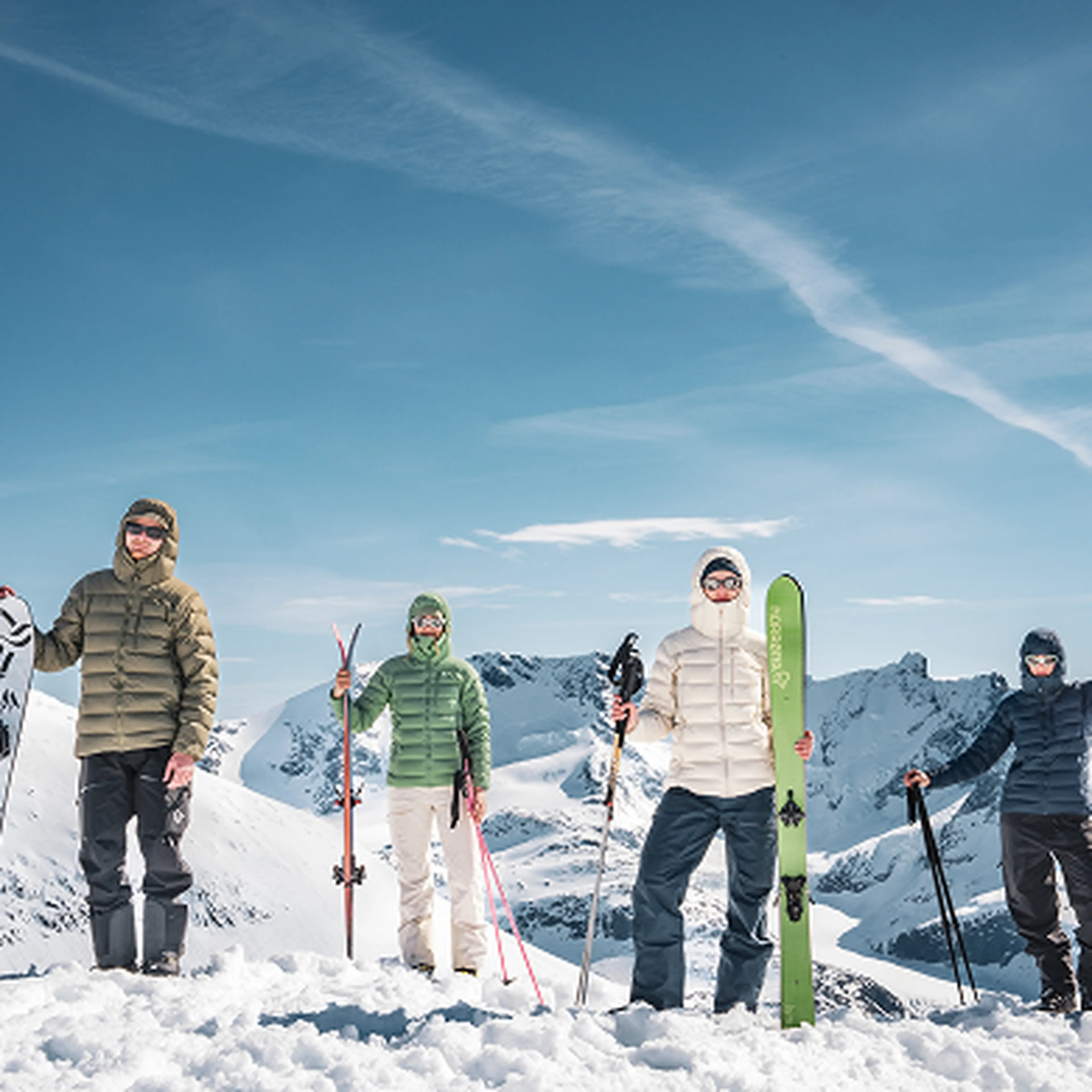 Group of peaople standing on mountain top in winter