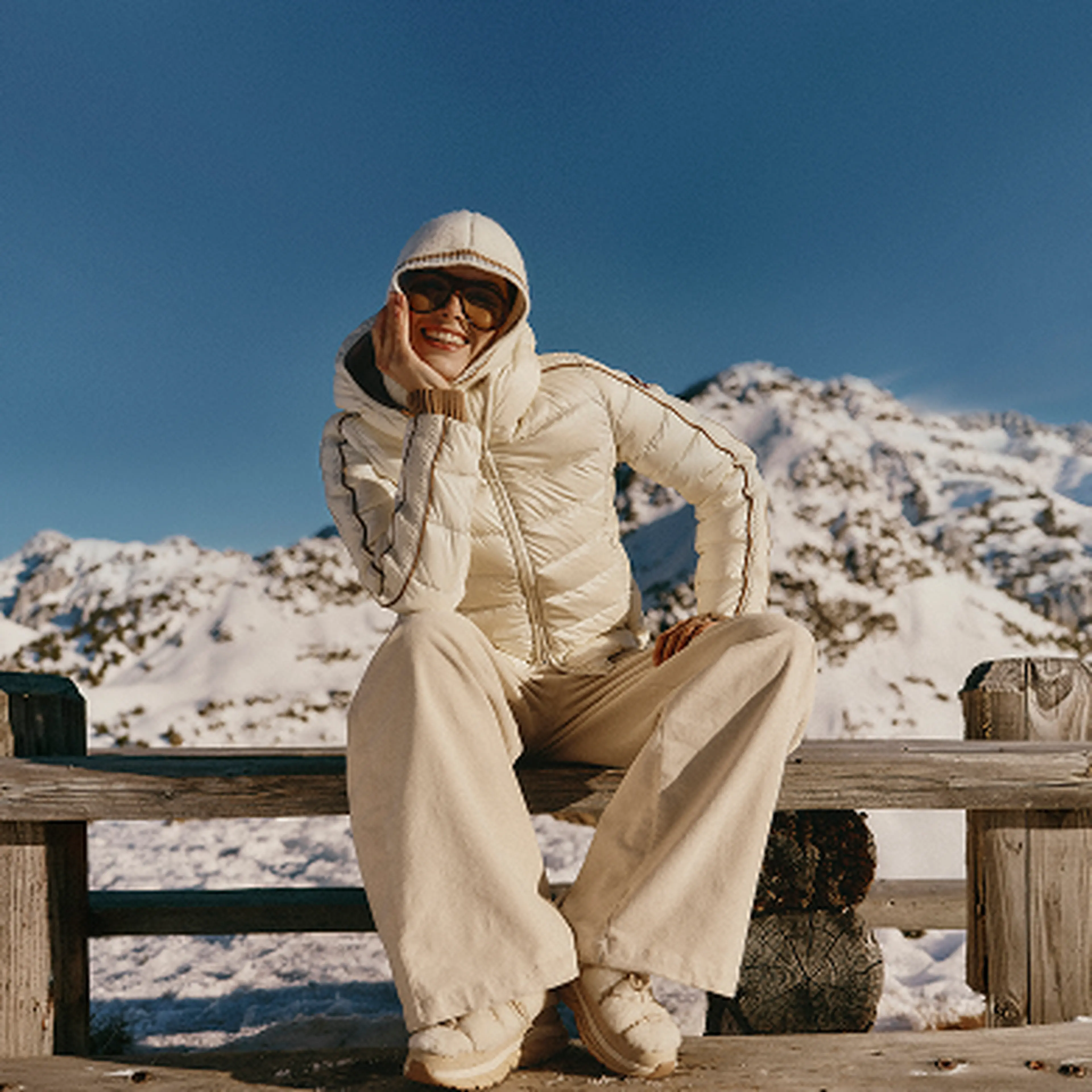 Woman sitting in the sunshine in the mountains