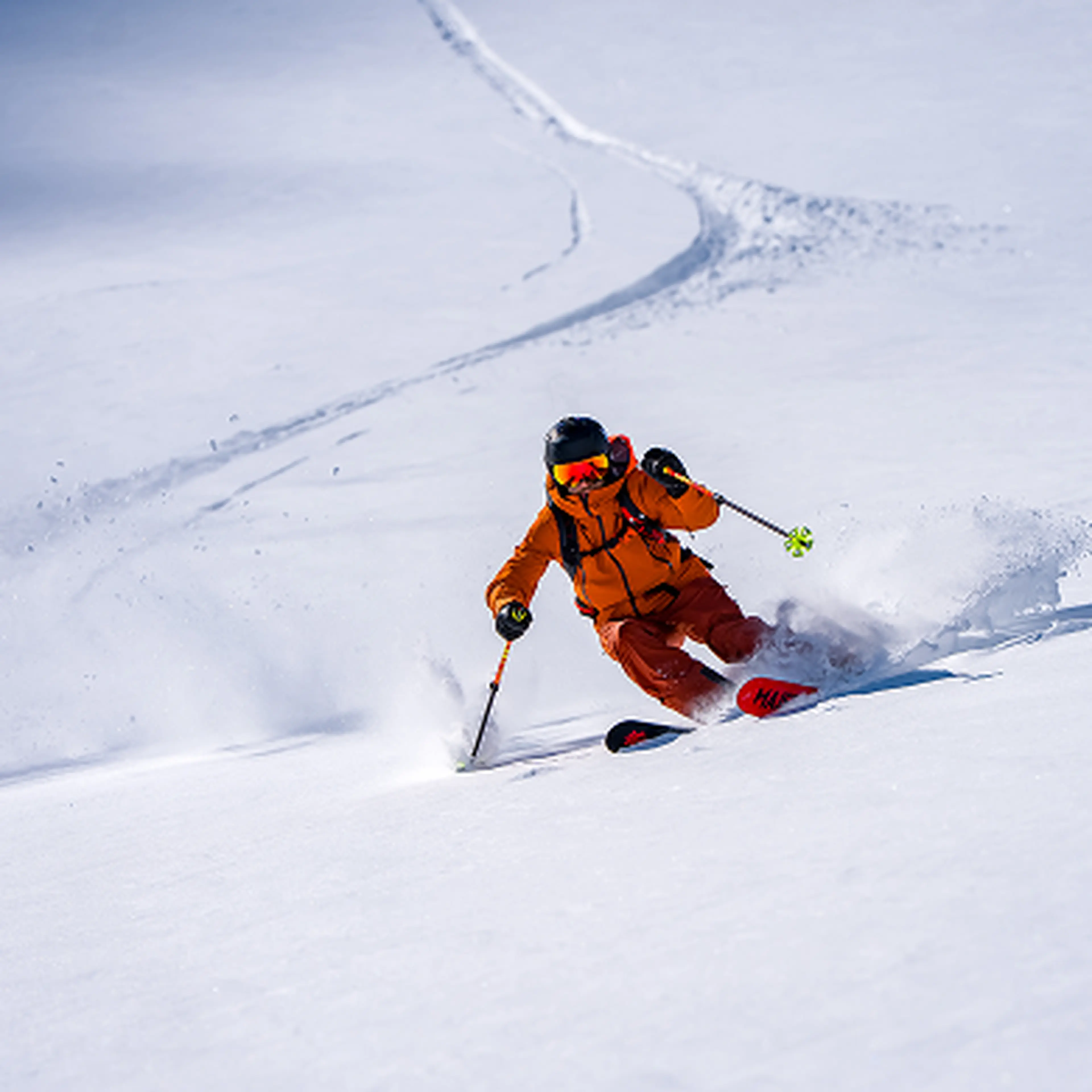 Skier in deep snow with orange clothes
