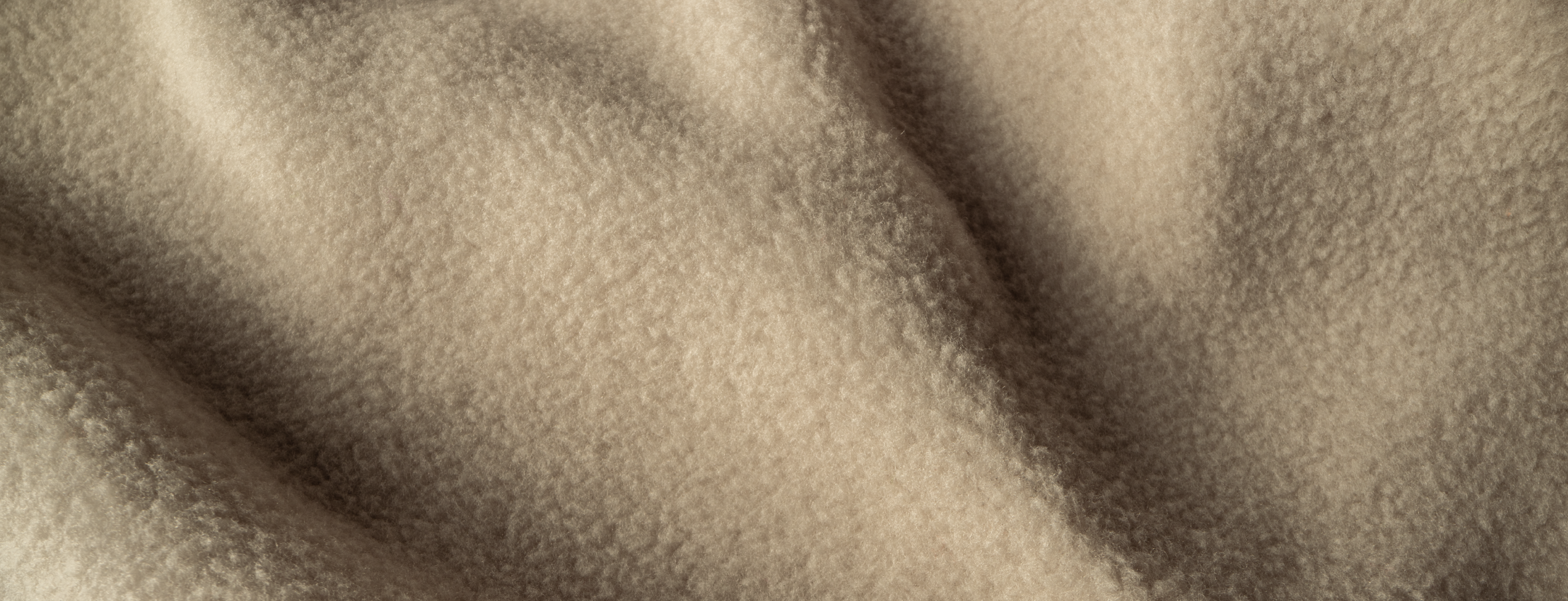 Closeup picture of a beige fleece fabric