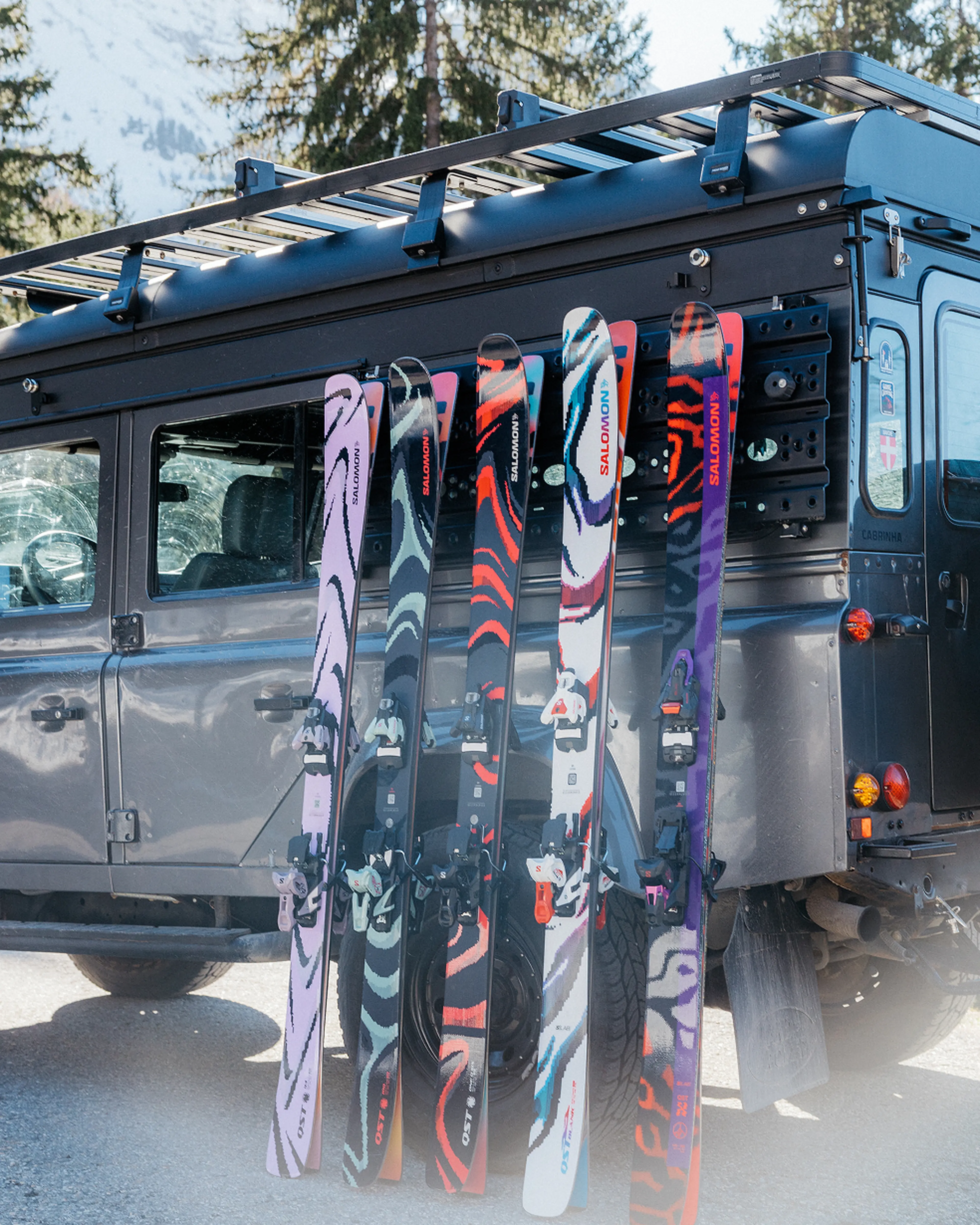 Picture of5 salomon skis lined up onto car