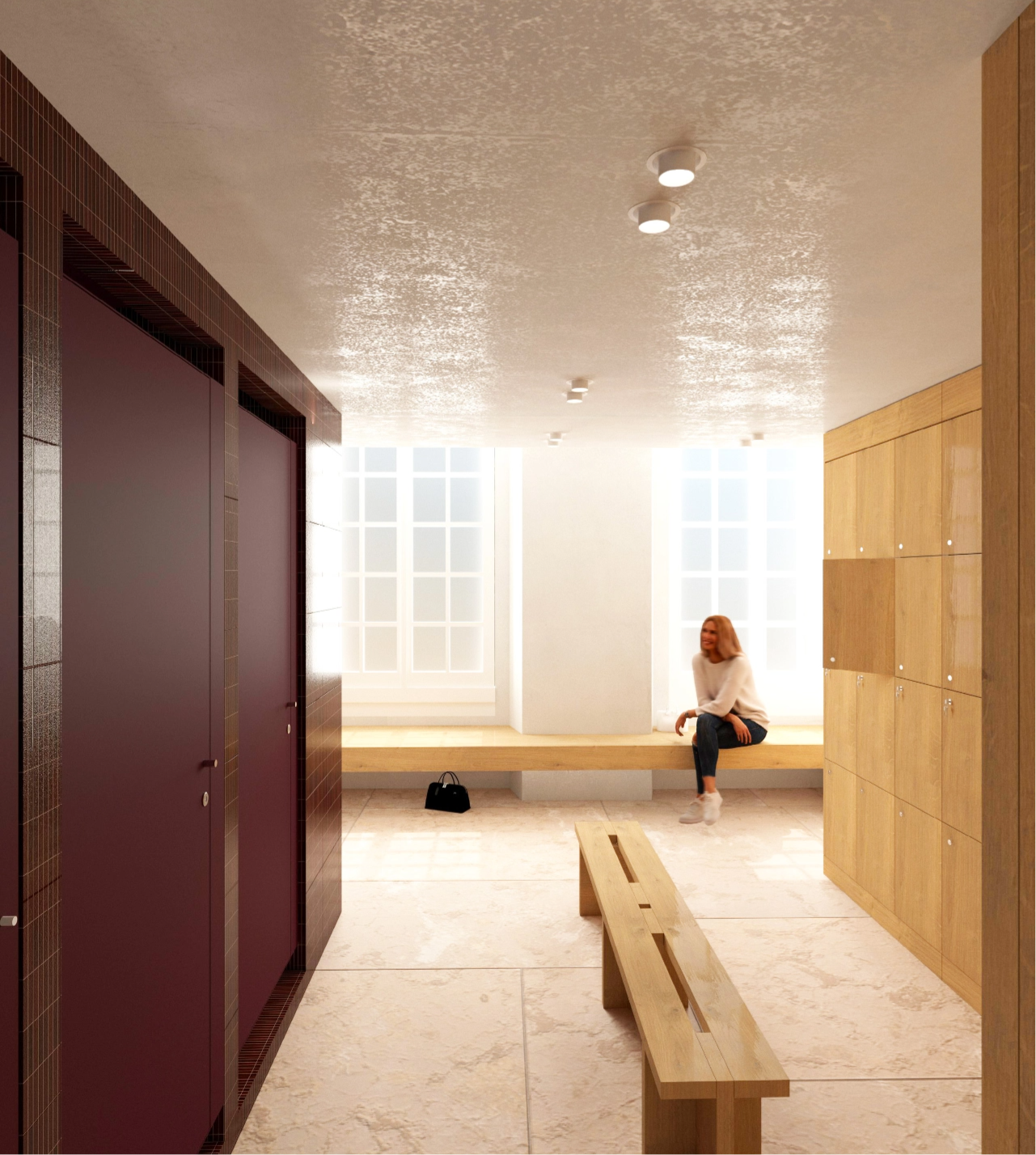 Caudalie Studio Woman sitting on a bench in a bright locker room with wooden lockers and maroon doors, under ceiling lights.