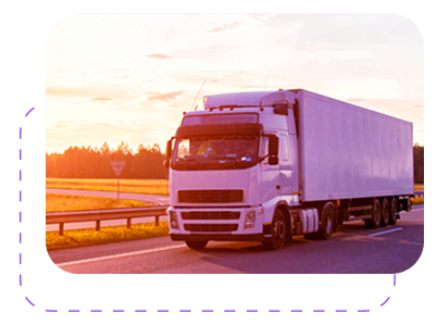 A white semi-truck driving on a highway at sunset, with fields and trees in the background.