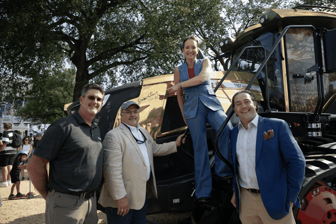 US-Landwirtschaftsministerin Brooke Rollins zeigt auf ihre Unterschrift auf dem goldenen Fendt-Traktor.