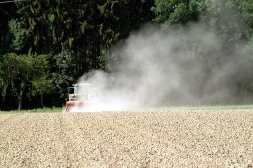 Traktor sät auf trockenem Feld