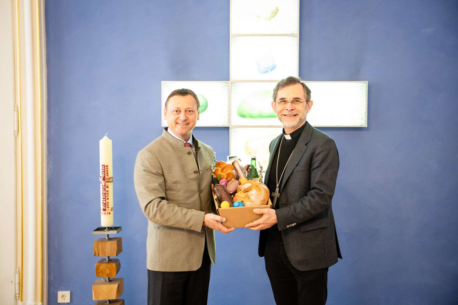 Johann Höfinger übergibt einen gefüllten Korb mit Köstlichkeiten an Erzbischof Josef Grünwidl.