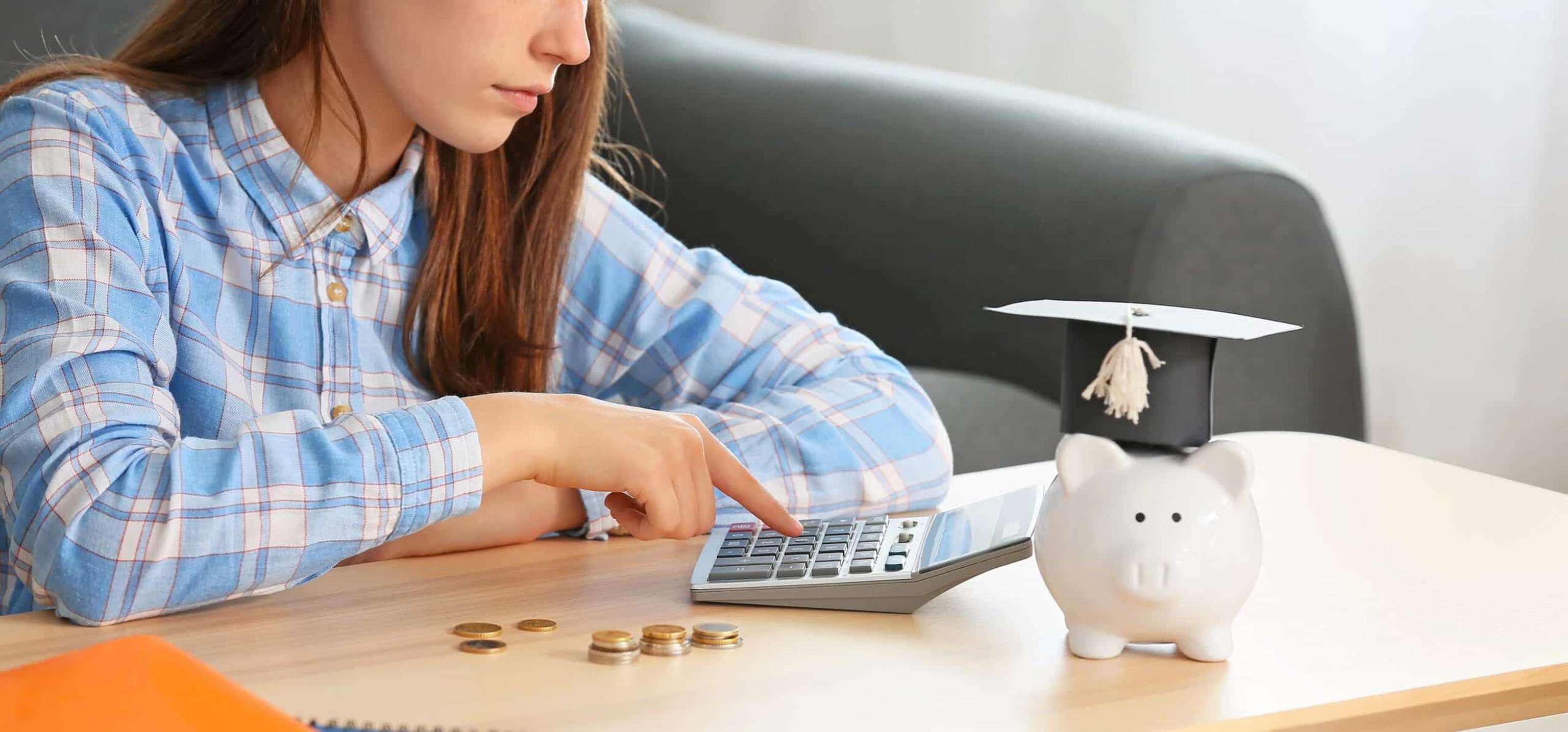 Teenage Girl With Savings For Education And Calculator At Home