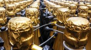 Many Bottles Of Champagne With Gold Foiled Bottleneck And Anti Theft Systems In Store. Front View