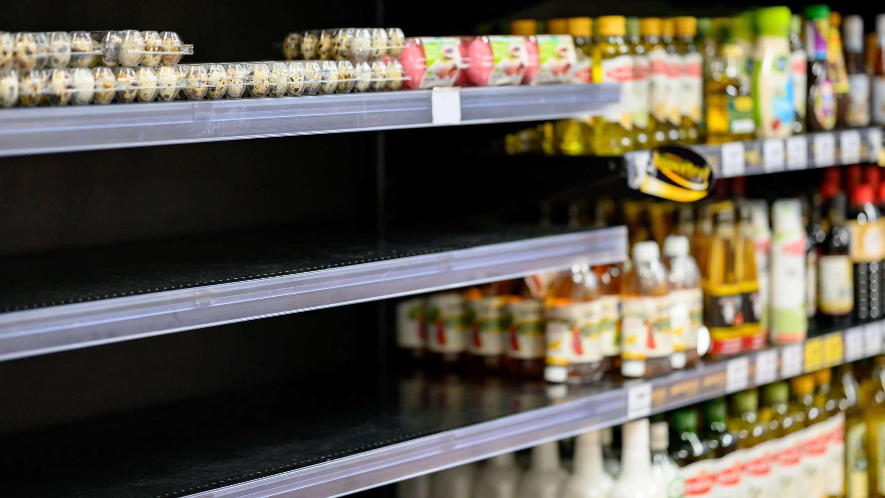 Empty Egg Shelves In A Grocery Store Or Supermarket. Hoarding Food Due To Coronavirus Outbreak. Prepare Food Supplies For The Worst Case Of COVID 19 Pandemic. Stockpiling Crisis All Around The World.