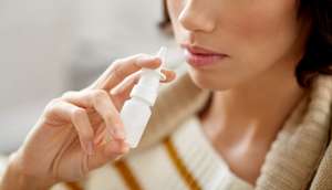 Close Up Of Sick Woman Using Nasal Spray