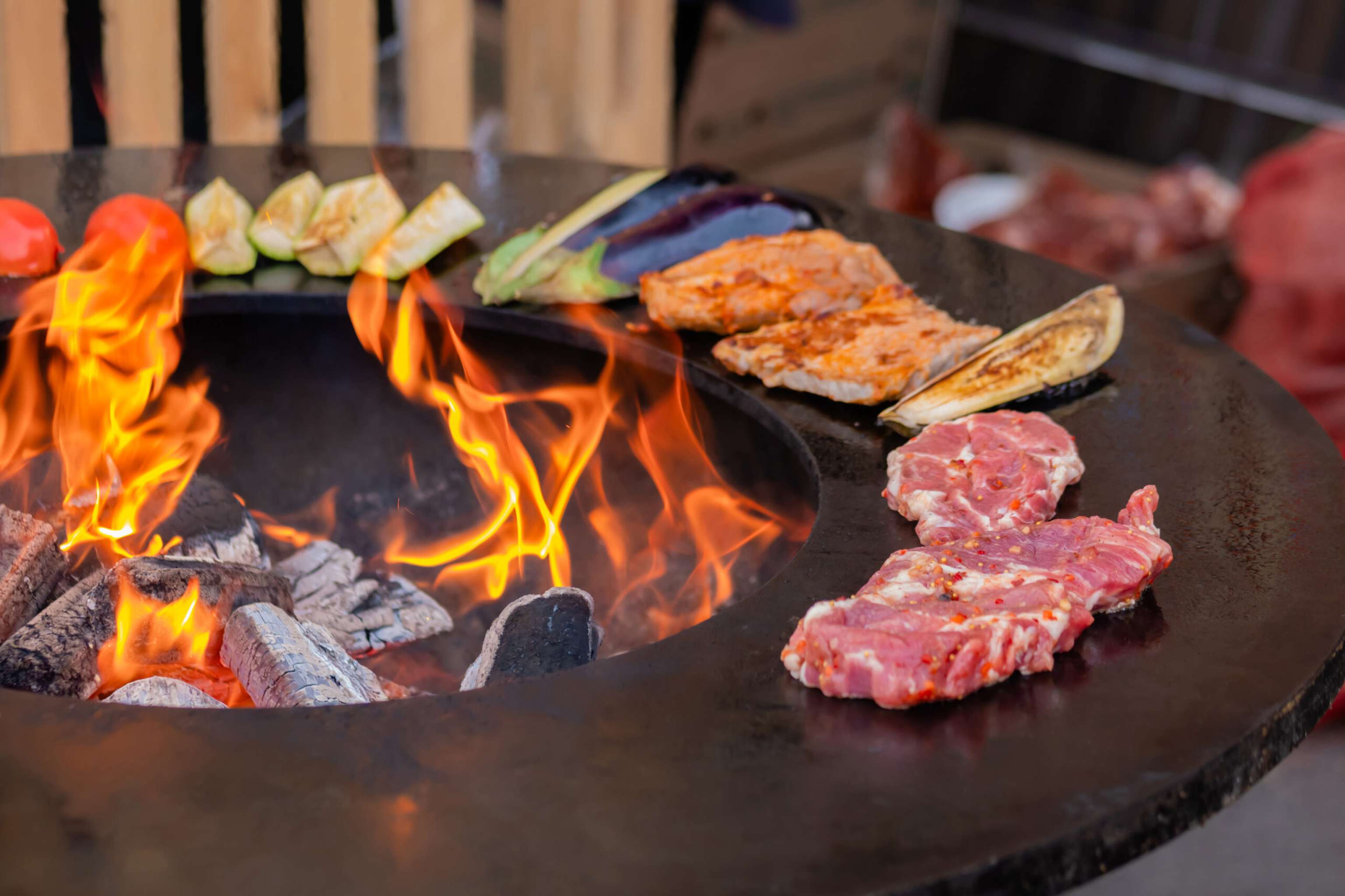 Process Of Cooking Meat Steaks, Zucchini, Eggplant, Tomato On Brazier Close Up