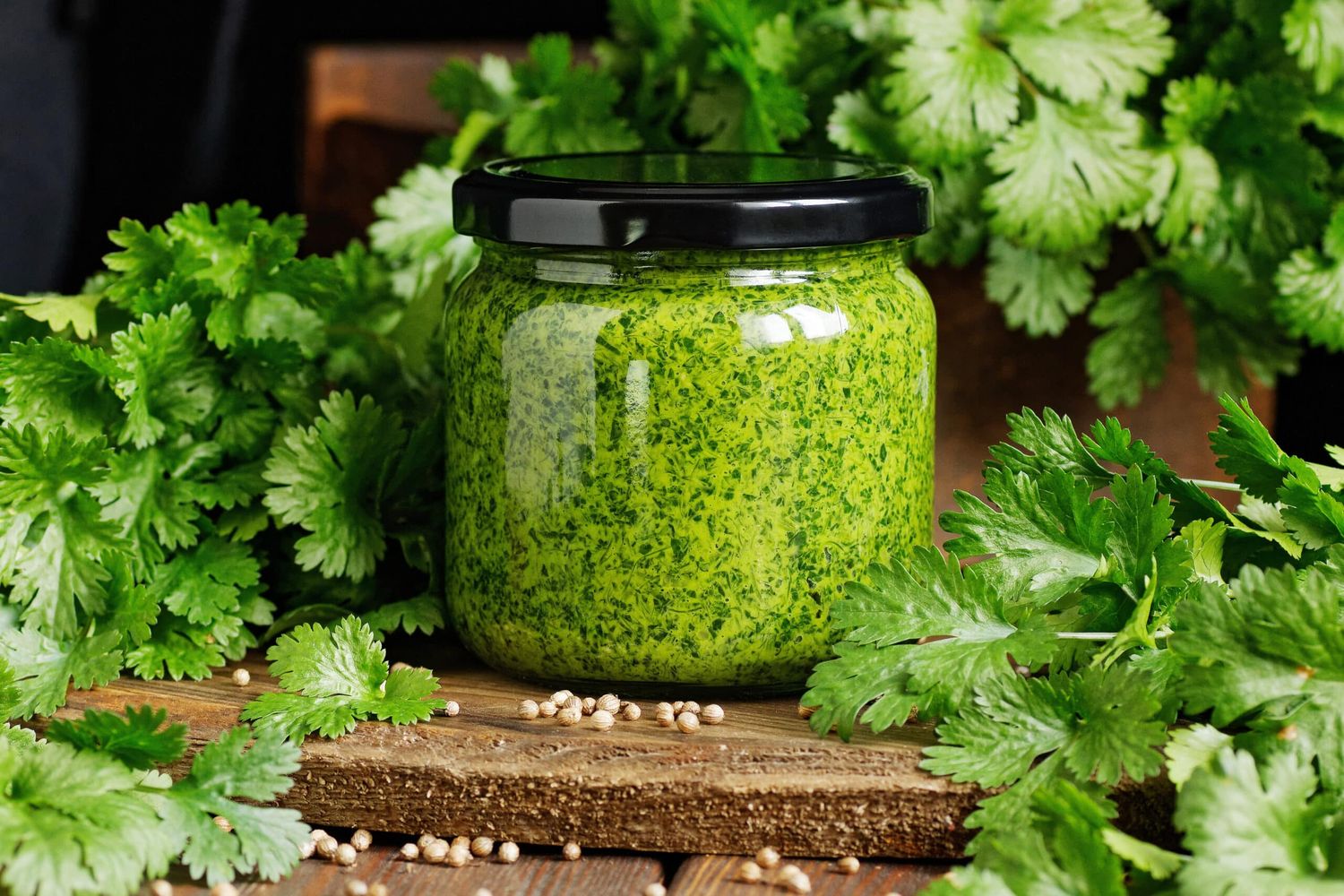 Green Pesto With Coriander Herb On Rustic Wooden Dark Background, Clloseup, Copy Space, Italian Dip Food And Dressing, Homemade Food Concept