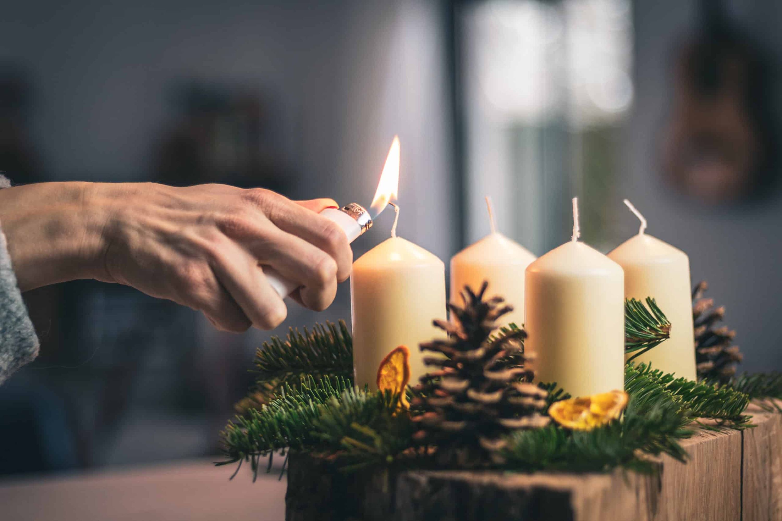 lighting a candle on advent wreath