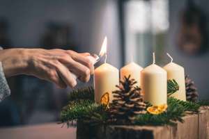 lighting a candle on advent wreath