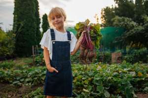 Little Girl Posing While Holding Beet