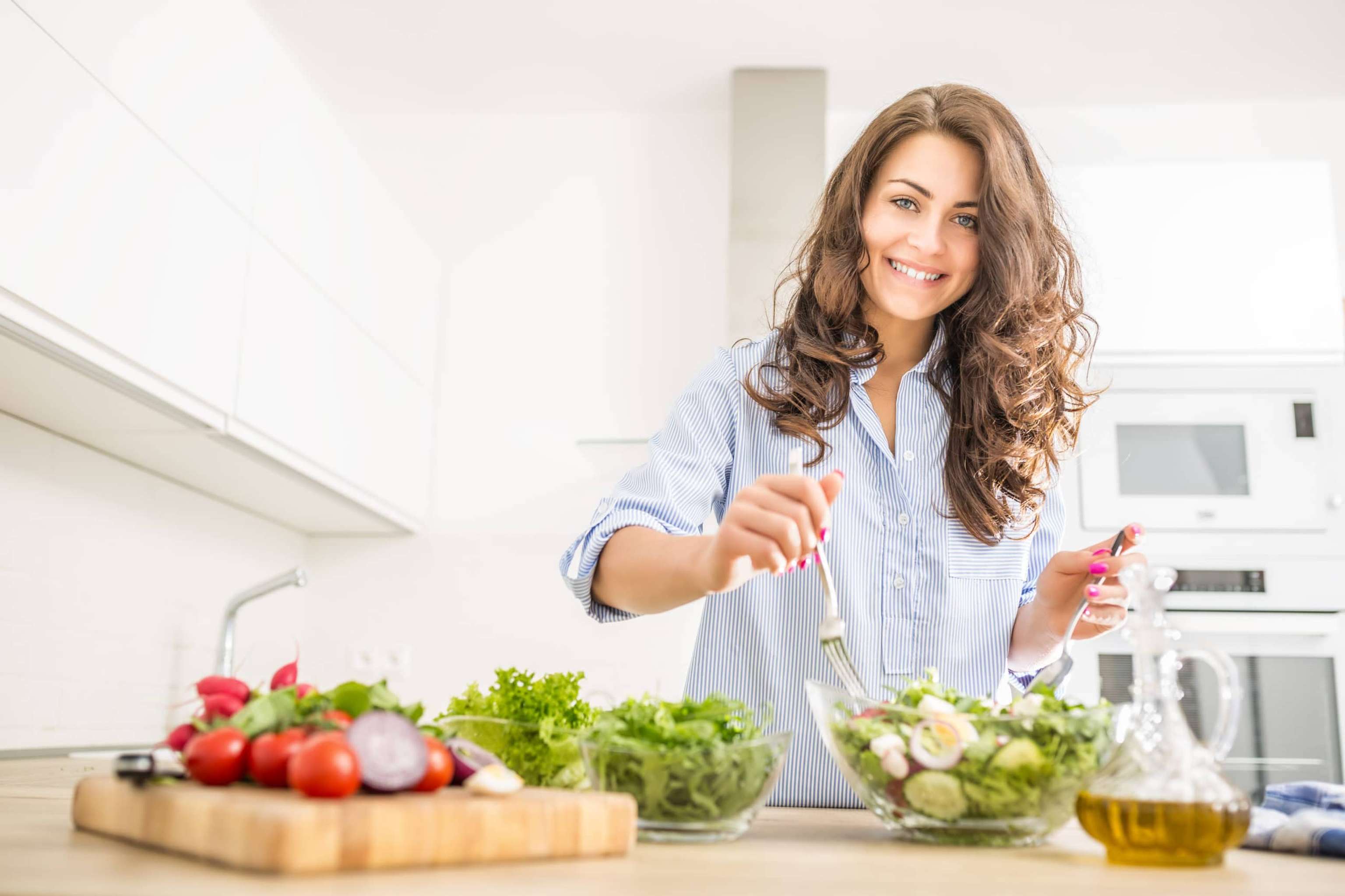 Young Woman Preparing Vegetable Salad In Her Kitchen. Healthy Lifestyle Concept Beautiful Woman With Mixed Vegetable.
