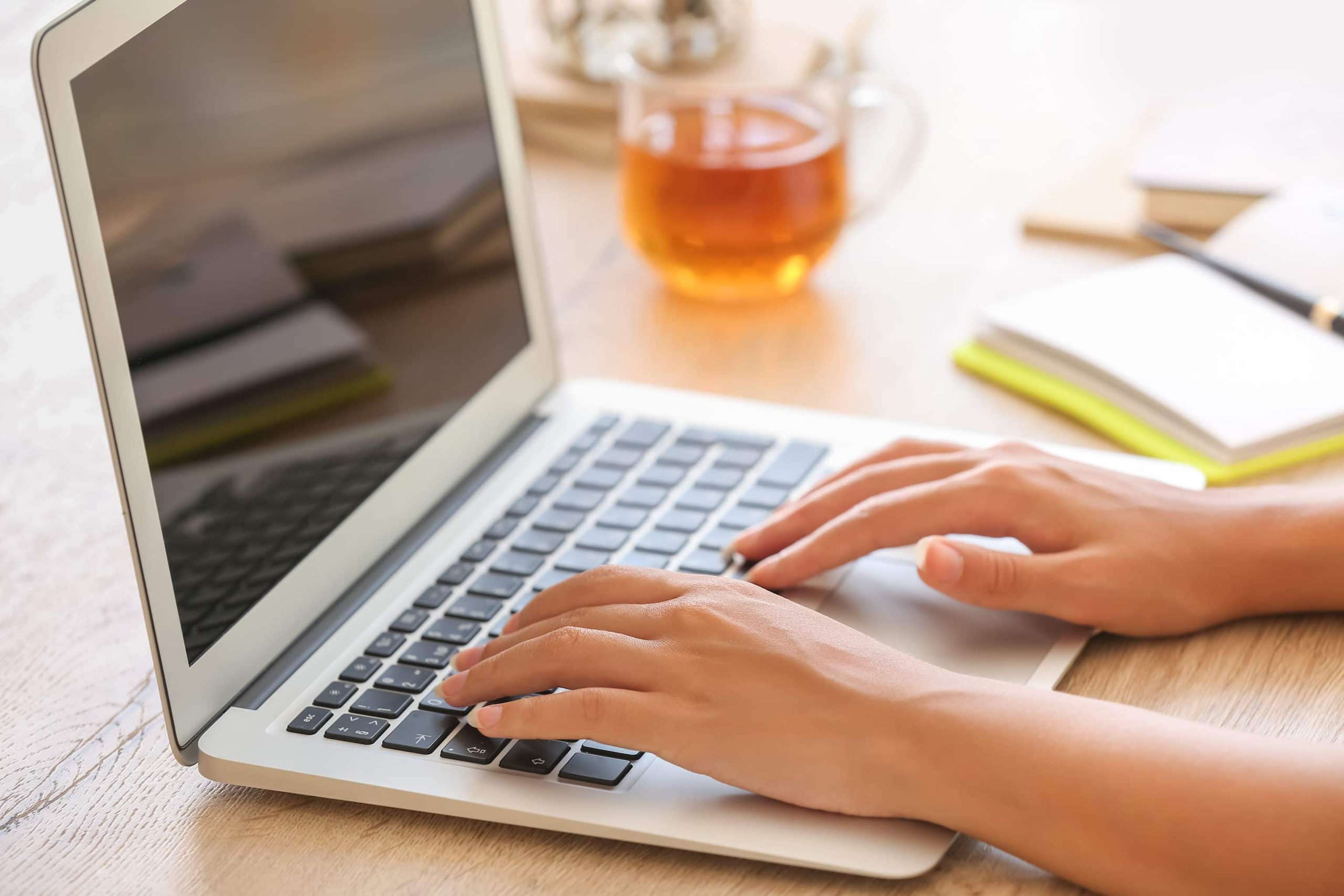 African American Woman Working On Laptop At Home, Closeup