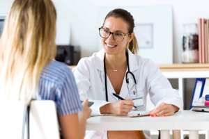 Female Doctor Explaining Diagnosis To Her Patient.
