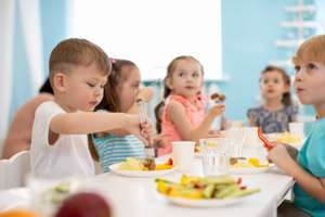 Kids Enjoying Healthy Lunch In Kindergarten