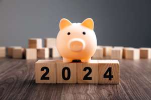 Piggy Bank On Top Of Wooden Block. Budget Plan 2024.