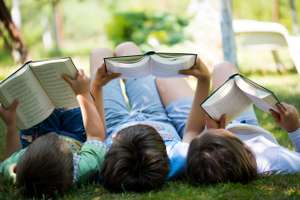 Three Children Reading In The Garden