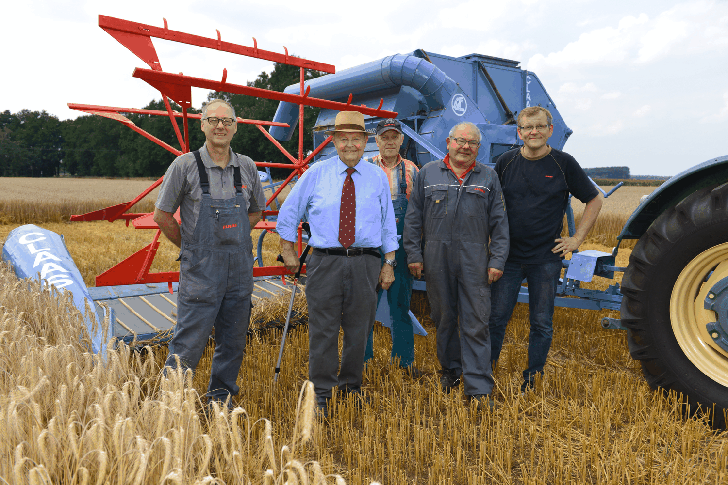 Beharrlich erfolgreich: Helmut Claas, hier inmitten seiner Mitarbeiter, vor einem 75 Jahre alten Mäh-Dresch-Binder Foto: Claas