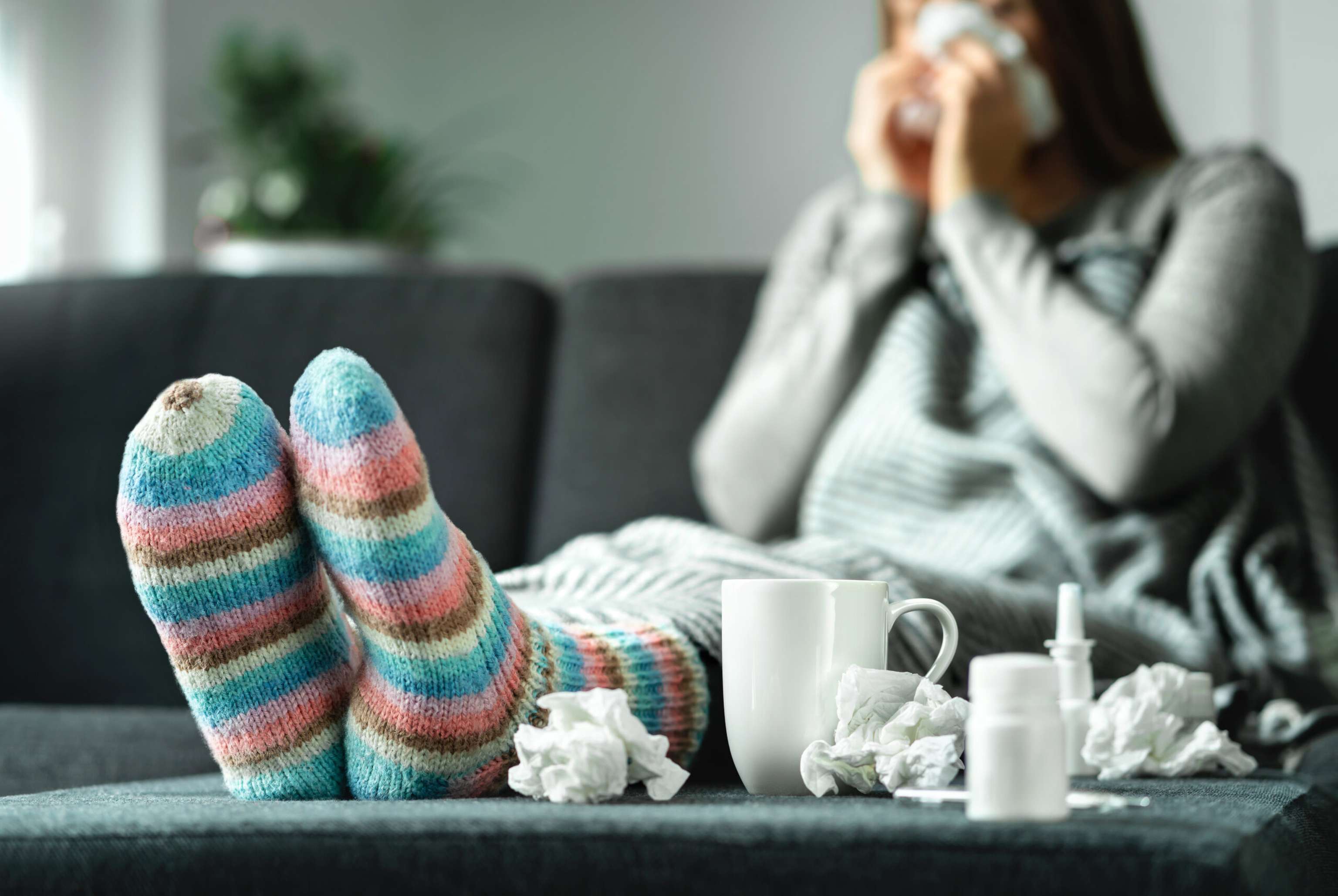 Sick Woman With Flu, Cold, Fever And Cough Sitting On Couch At H