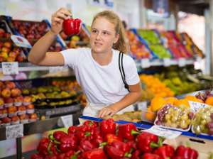 Girl Customer Buying Red Pepper At Grocery Shop