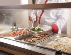 Chef Standing Behind Full Lunch Service Station