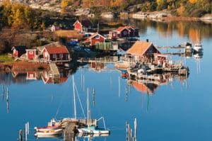 Typisch Schweden: Rote Holzhäuschen in idyllischer, wasserreicher Landschaft
