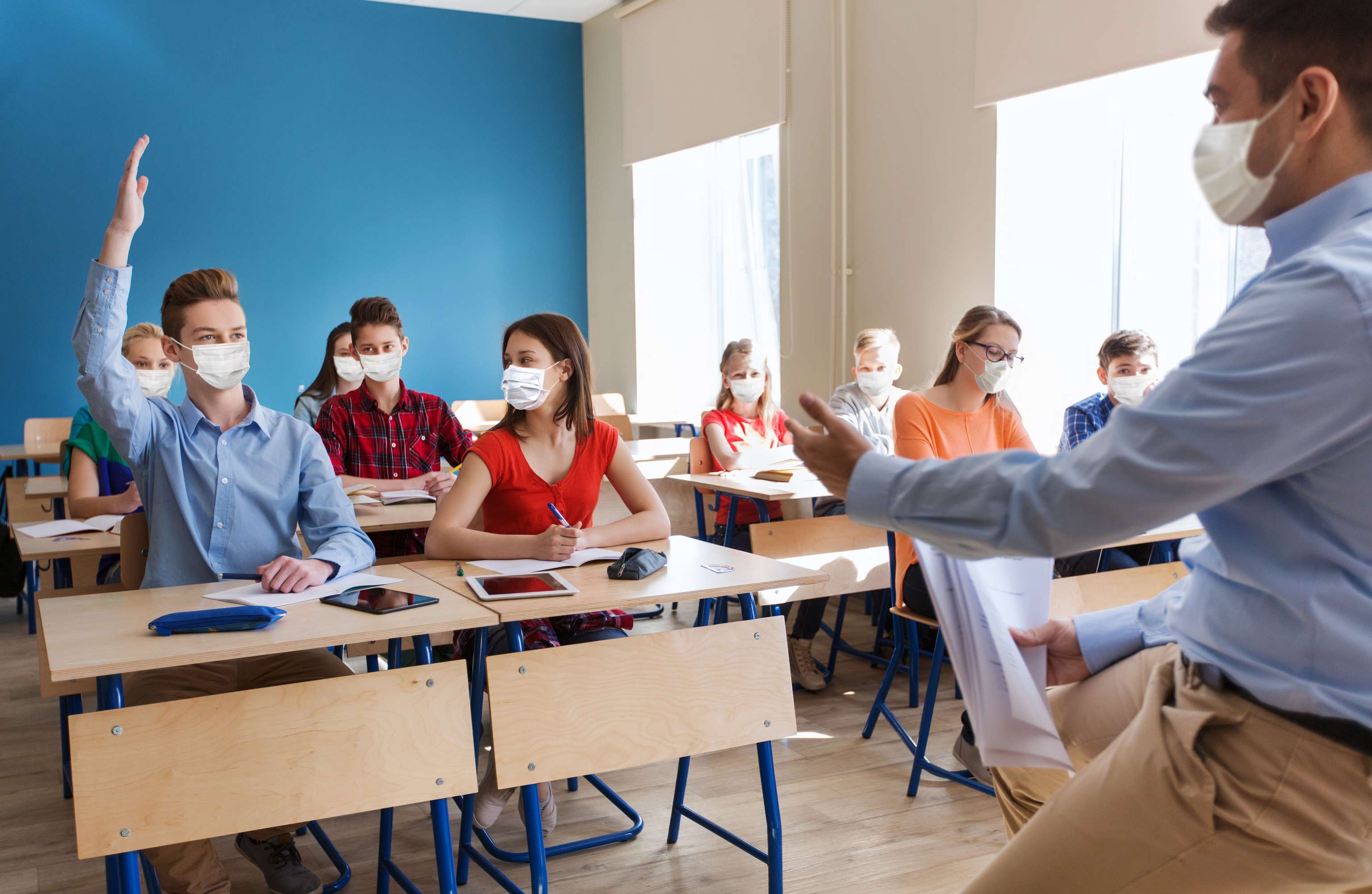 Group Of Students And Teacher In Masks At School